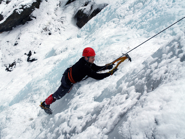Man climbing frozen waterfall - Fotoğraf, Görsel