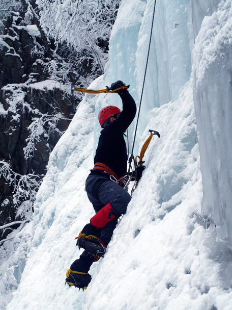 Man climbing frozen waterfall - Photo, Image