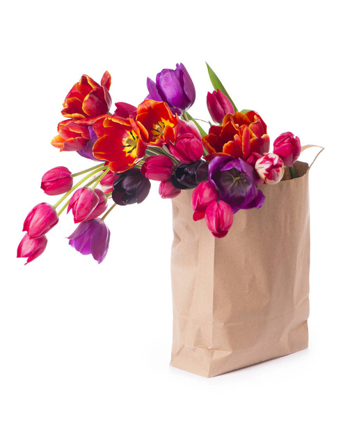 Beautiful bouquet of purple tulips in paper bag - Foto, imagen