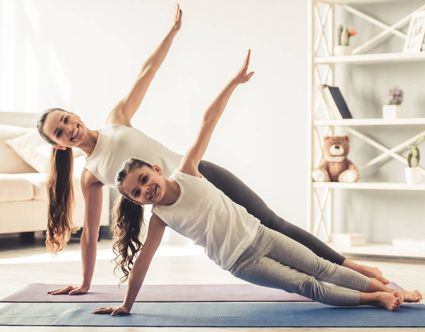 Mom and daughter doing yoga - Photo, image