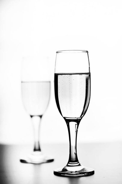 monochrome photo of champagne on white table on white background - Foto, Bild