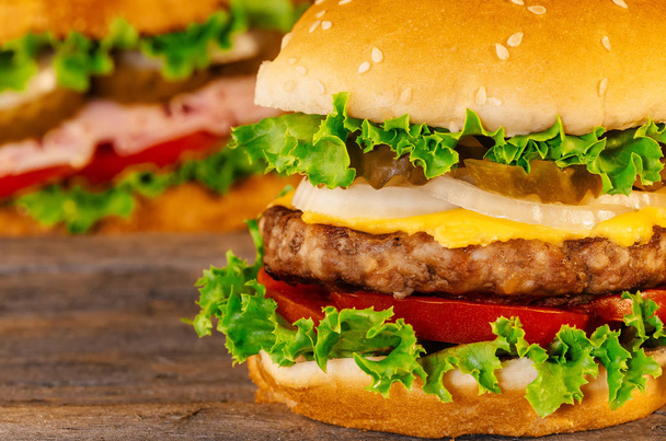 Closeup of home made burgers wooden background - Foto, imagen