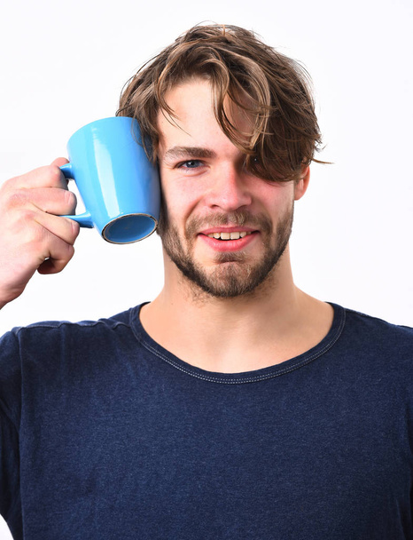 Caucasian sexy young macho holding coffee cup or mug - Foto, afbeelding