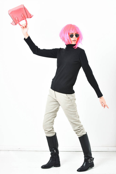 fashionable sexy girl in pink wig posing with fashion bag - Фото, изображение