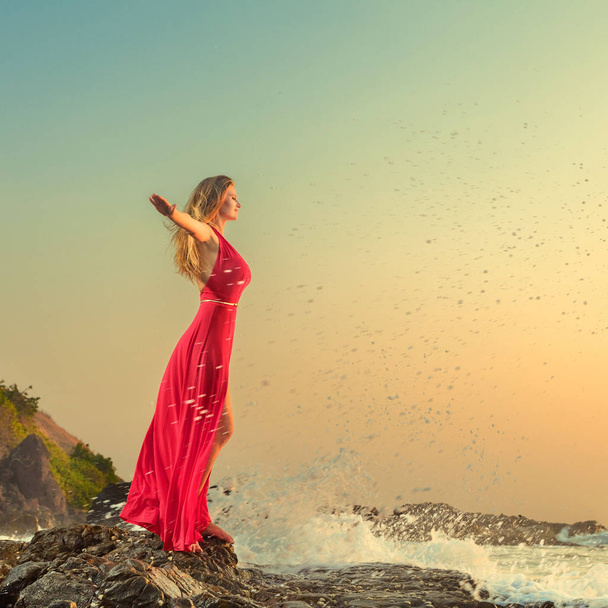 Woman in long dress in front of sea - Фото, изображение