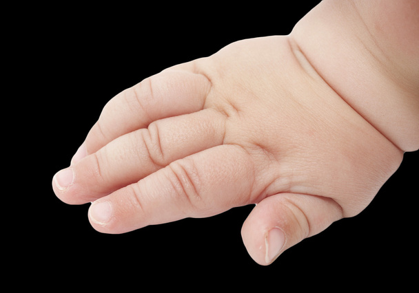 Baby's hand on a black background - Photo, Image