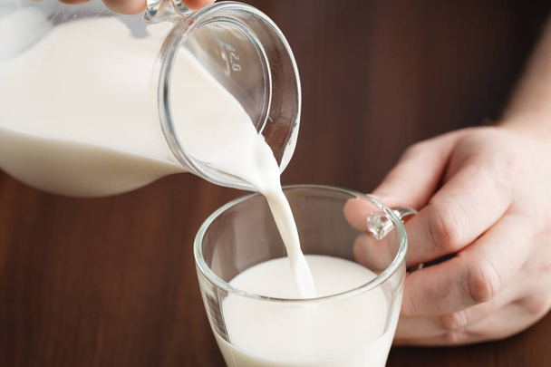 Pouring milk into glass - Fotoğraf, Görsel