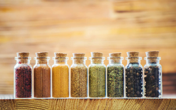 spices in jars on wooden background. selective focus. - Foto, Imagem