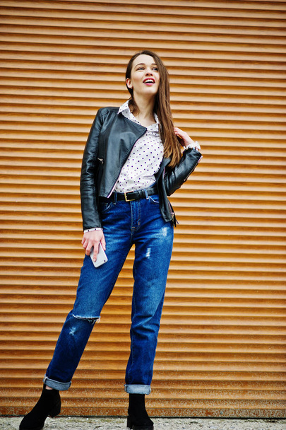 Portrait of stylish young girl wear on leather jacket and ripped - Zdjęcie, obraz