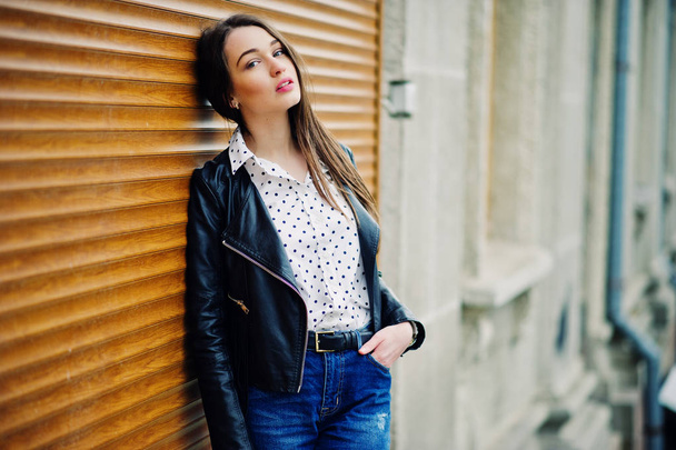 Portrait of stylish young girl wear on leather jacket and ripped - Фото, изображение