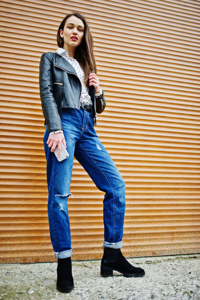 Portrait of stylish young girl wear on leather jacket and ripped - Фото, зображення