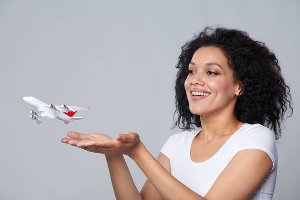 Woman launching airplane - Фото, изображение