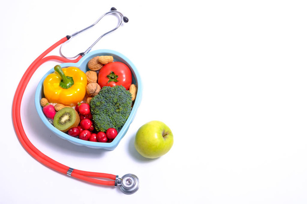 Heart shaped dish with vegetables and stethoscope  - Photo, Image