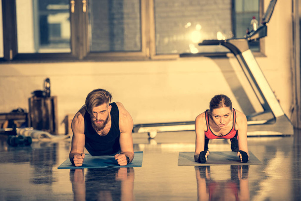 Man and woman doing plank exercise  - Photo, Image