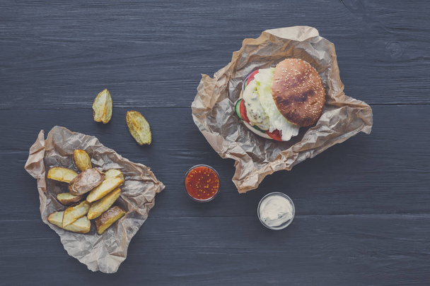 Fast food restaurant dish. Hamburger and potato wedges - Photo, Image