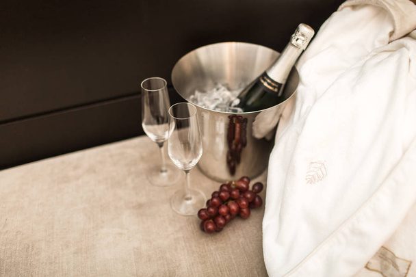 bottle of champagne and glasses in hotel room - 写真・画像