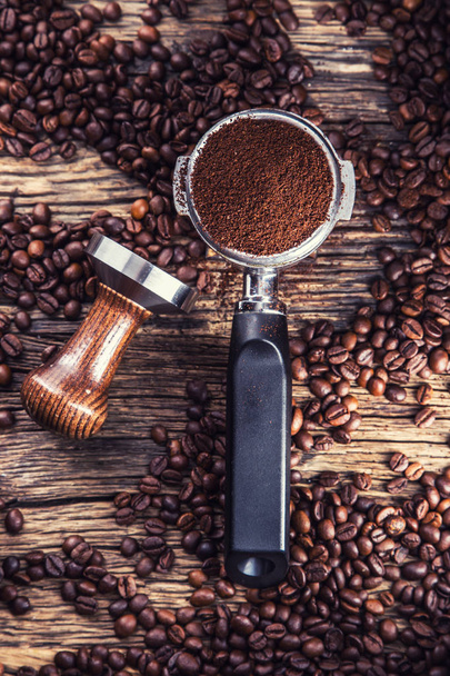 Coffee.Coffee beans and portafilter on old oak wooden table - Fotografie, Obrázek