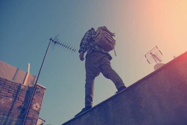 Traveler walking over high roof in the city - Fotografie, Obrázek