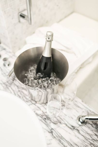 bottle of champagne and glasses in hotel room - 写真・画像