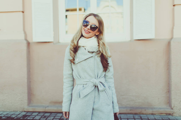Young pretty woman in sunglasses on spring streets - 写真・画像