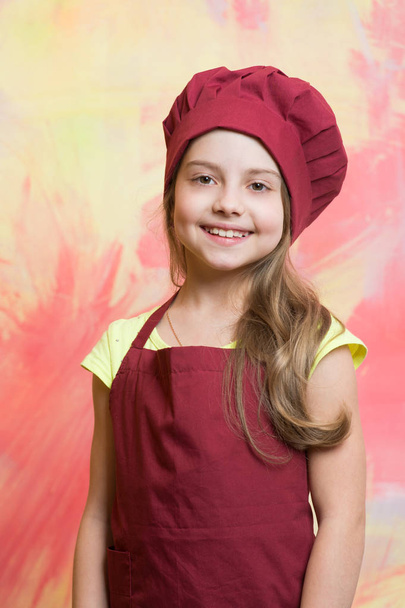 small girl chef with happy face in hat and apron - Fotó, kép