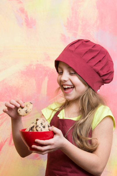 small happy girl chef in hat, apron with cookies bowl - Φωτογραφία, εικόνα