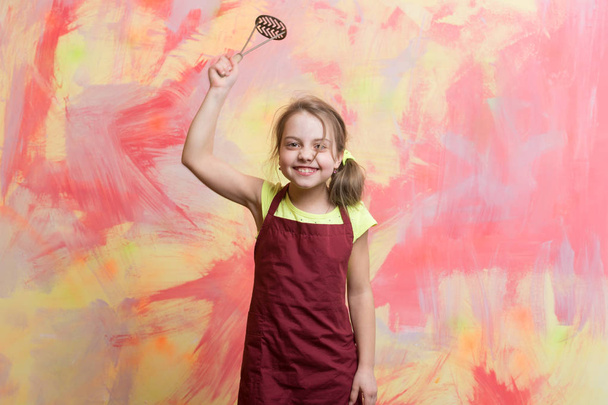 small happy girl chef in cook apron holding cooking tool - Foto, imagen