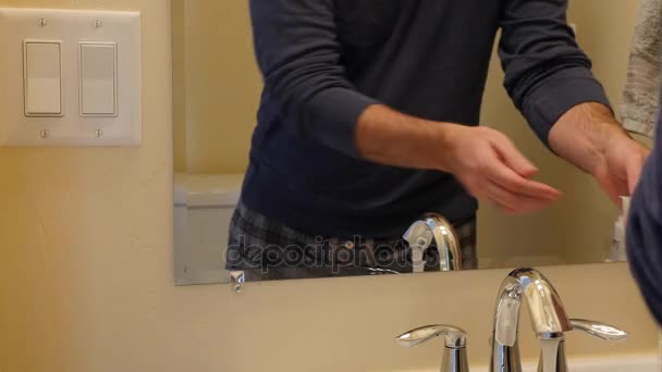 A man washes his hands in the bathroom  - Felvétel, videó
