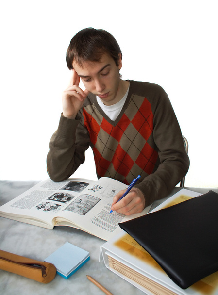 Студент-мужчина за столом, держит голову
 - Фото, изображение