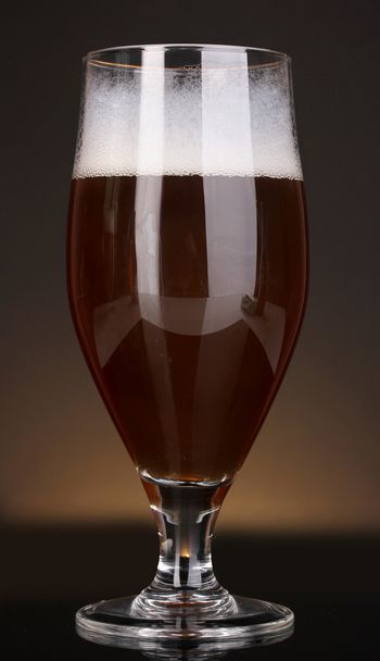 Glass of beer on brown background - Photo, Image