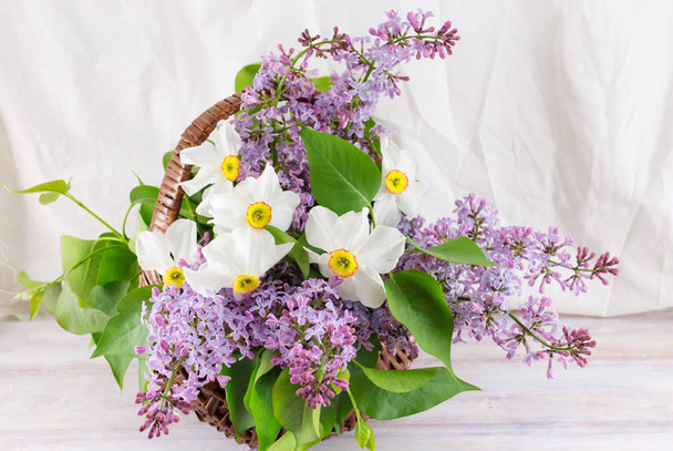Lilac and narcissus flowers in a basket - Photo, image