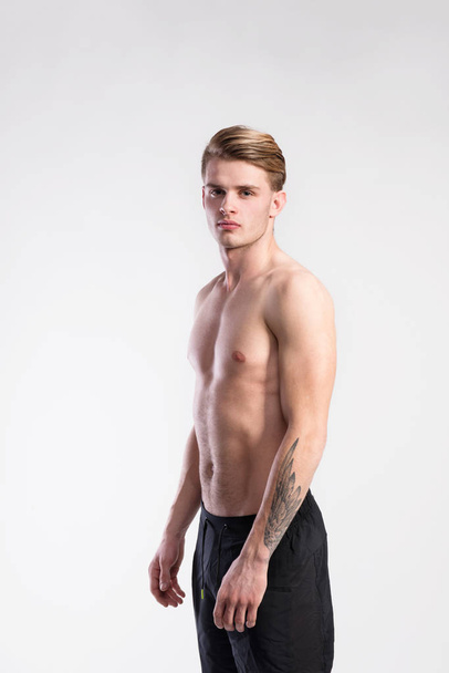 Young handsome hipster shirtless fitness man. Studio shot. - Photo, Image