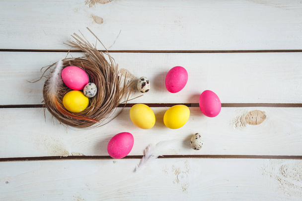 Easter background with yellow and pink eggs . Top view with copy space . - 写真・画像