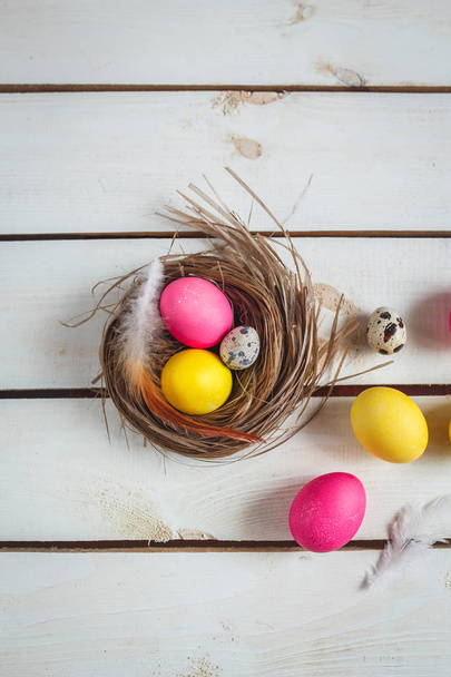 Easter background with yellow and pink eggs . Top view with copy space . - Fotografie, Obrázek