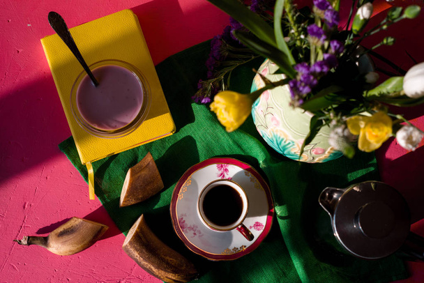 Jug with flowers, yogurt, cup of coffee on a napkin - Foto, Imagem