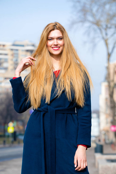 Portrait of a young beautiful woman in blue coat  - Foto, Imagem