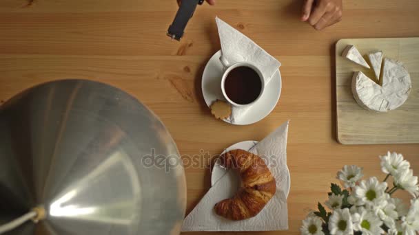 Womans Hand Takes A Cup Of Coffee And A Smart Watch. Top View. - Imágenes, Vídeo