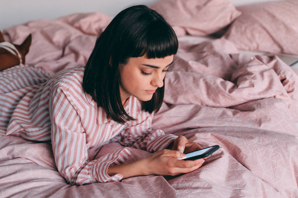 Хипстерская девушка, лежащая в постели с кофе
 - Фото, изображение