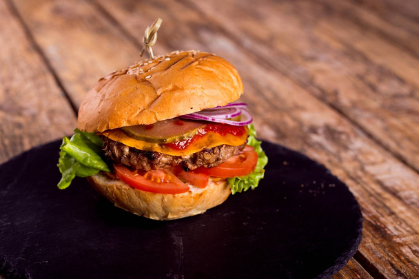 beef Burger with cheese and bacon on wooden background - Foto, immagini