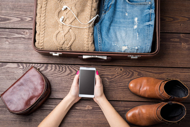 Travel preparations concept with open suitcase and woman's casual clothes - Foto, Imagem