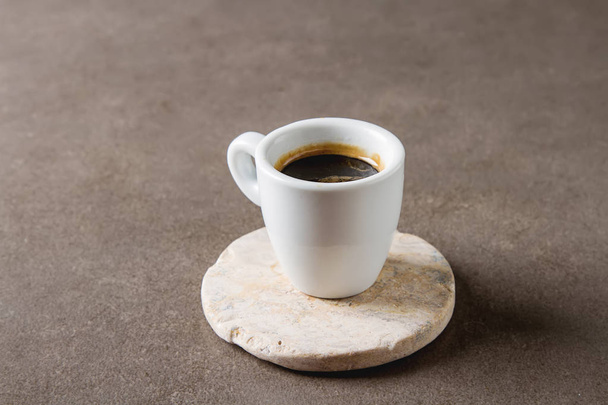 Italian homemade espresso coffee in a white mug. Dark background - Foto, immagini
