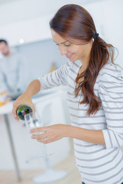 woman filling the glass with red wine - Zdjęcie, obraz