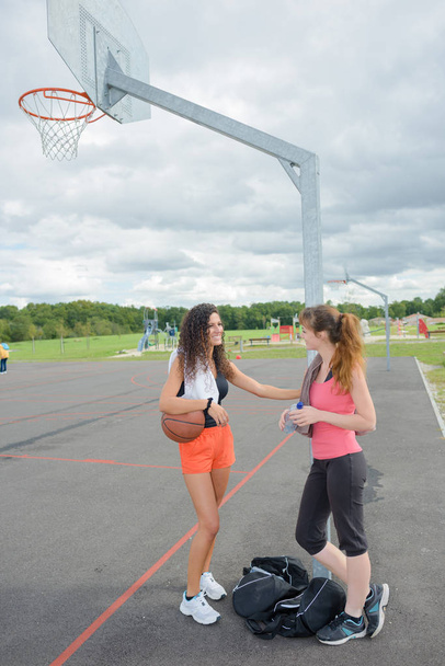 Two women on outdoor basketball court - Fotoğraf, Görsel