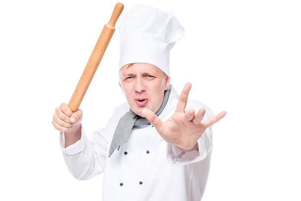 portrait of an angry chef with a wooden rolling pin in the studi - Photo, Image