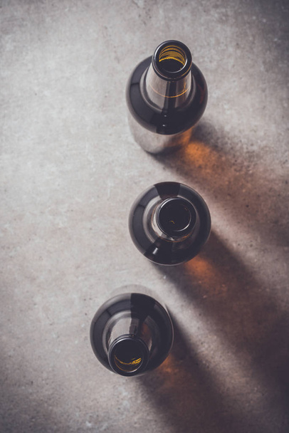 Beer bottles on dark table - Φωτογραφία, εικόνα