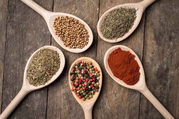 Herbs and spices on wooden spoons - Valokuva, kuva