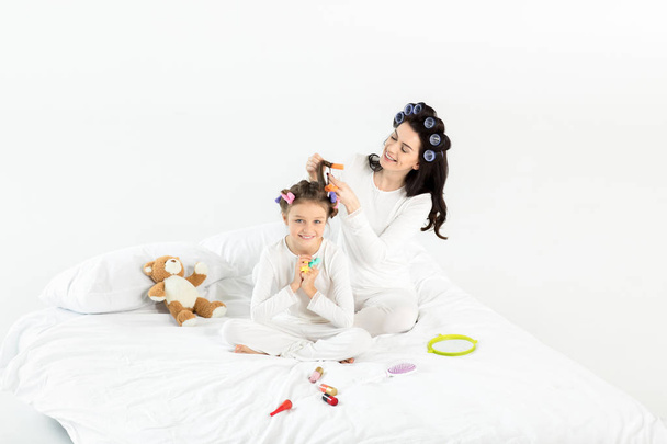 Mother and daughter in curlers  - Photo, Image