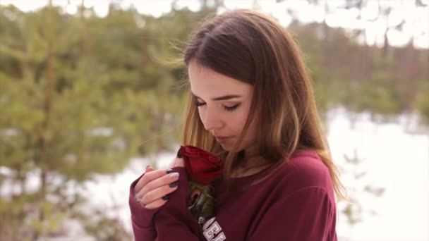 Girl with a red rose in the winter woods.Full hd video. - Felvétel, videó