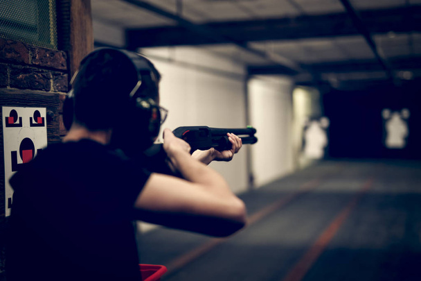 Man shooting in indoor firing range - Photo, Image