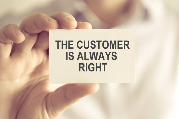 Businessman holding THE CUSTOMER IS ALWAYS RIGHT message card - Фото, изображение